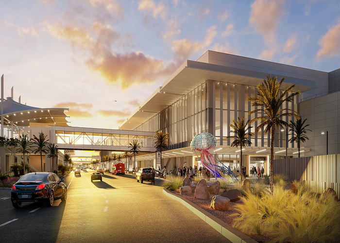 San Diego International Airport entrance with cars and palm trees at sunset